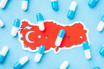 Wall Mural - Health care system of Turkey. Blue and white pills capsules on the map of Turkey