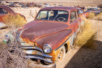 Exterior of a junked vintage retro vehicle in a junkyard.