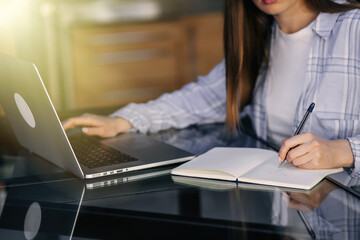 hands of a woman freelancer or student sitting at a desk, workin