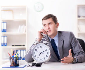 Businessman employee in urgency and deadline concept with alarm