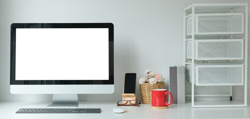 Wall Mural - Modern workspace with computer with blank screen and equipment on white table.Blank screen for your information.