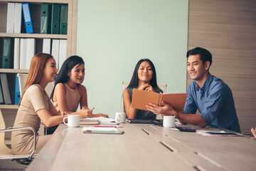 Wall Mural - Happiness diversity business team meeting corporate office desk in company meeting room. Asian team group partner brainstorming discussion multiethnic people sitting share ideas teamwork in boardroom