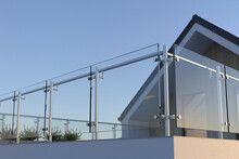 Modern Stainless Steel Railing With Glass Panel And House, 3D Illustration
