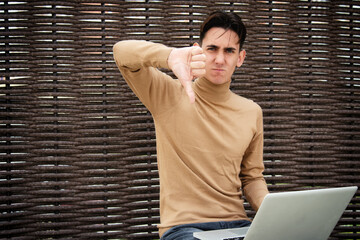 Funny young man with laptop. Freelancer and web design. Business strategy. Online training in the fresh air.