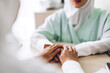 © Art_Photo - Muslim asian woman doctor service help support discussing and consulting talk to muslim woman patient and holding hand at meeting health medical care express trust concept in hospital.healthcare