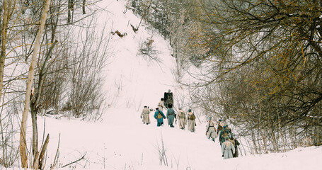 Wall Mural - Men Dressed As White Guard Soldiers Of Imperial Russian Army In Russian Civil War Times Marching Through Snowy Winter Forest. Historical Reenactment 1917-1922.