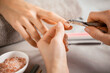 Manicurist using cuticle pusher