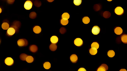 Wall Mural - blurry golden bokeh lights on a black background