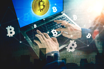 Hacker using laptop to steal information of bitcoin