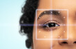 vision correction, laser eye surgery and health concept - close up of young african american woman face over blue background