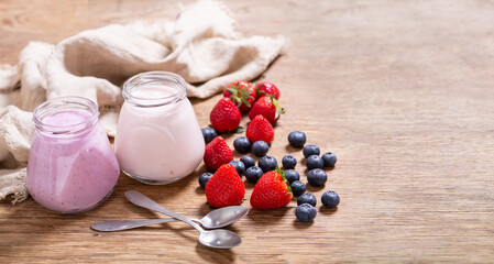 Wall Mural - glass jars of yogurt with fresh berries