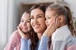 © Syda Productions - people, family and love concept - happy smiling mother with two daughters at home
