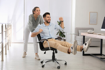 Sticker - Office employee giving her colleague ride in chair at workplace