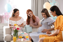 Happy Pregnant Woman Spending Time With Friends At Baby Shower Party