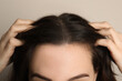 © New Africa - Woman suffering from baldness on grey background, closeup