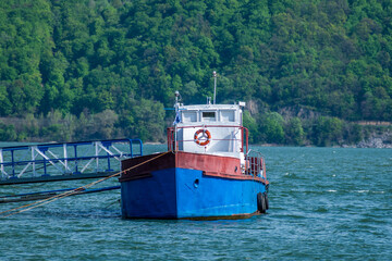 Wall Mural - Ship anchored on the Danube. Small cruise ship