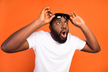 Photo Of Amazed Astonished Afro American Young Man Look Empty Space Hold Glasses Isolated On Orange Color Background