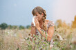 Woman in meadow snorts in handkerchief