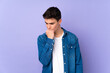© luismolinero - Teenager caucasian  handsome man isolated on purple background having doubts