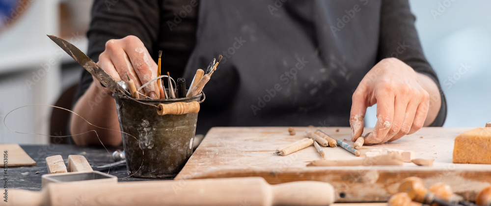 Working process of pottery with tools - obrazy, fototapety, plakaty 