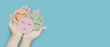 Woman hand holding emotion group of paper cut happy smile face, angry and boring face on blue background, positive and negative thinking, mental health assessment , world mental health day concept