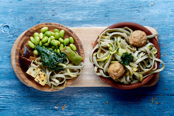 Canvas Print - high angle view of two vegan dishes on a table