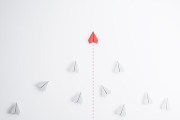 Leadership concept with red paper plane going ahead white paper planes on abstract light background