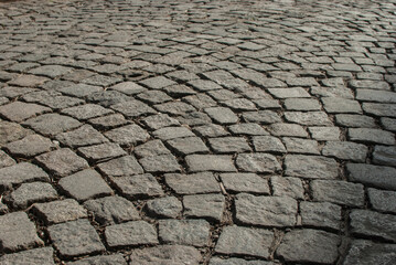 Wall Mural - Stone paving roadway surface closeup as stone background