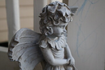 Angle stone statue close up face on front porch 