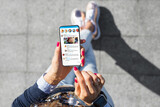 Fototapeta  - Woman using social media microblogging app on her phone