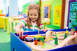© famveldman - Kids play wooden railroad. Child with toy train.