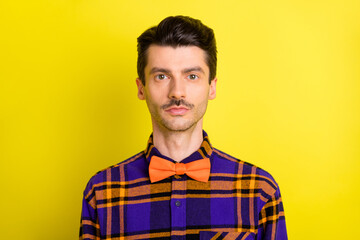 Sticker - Photo of young handsome man confident serious wear plaid shirt bowtie isolated over yellow color background