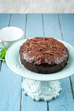 Traditional Austrian Sacher Chocolate Cake With Crumbles Served As Close-up On An Ceramic Cake Plate