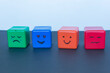 Different emotions concept, funny faces drawn on cubes.