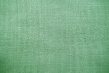Texture Of Natural Green Fabric Close-up. The Texture Of The Fabric Is Made Of Natural Cotton Or Linen Textile Material. Green Canvas Background. Smooth Surface, Smoothed Fabric