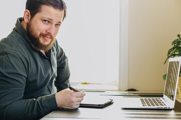 Wall Mural - Businessman using smatrphone and laptop working at office.