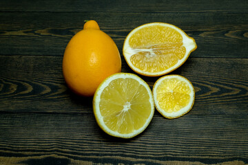 Wall Mural - Ripe source lemons  on a wooden background  photographed from above