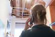 © roberjzm - Woman talking to homeowner's insurer while inspecting kitchen ceiling