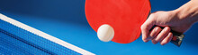 Hand With A Ping Pong Racket Hitting The Ball Above The Table Banner