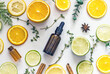 Natural citrus cosmetics with vitamin C, cosmetic bottle, citrus circles, lime, orange, lemon. Vitamin C serum bottle with pipette, amber glass