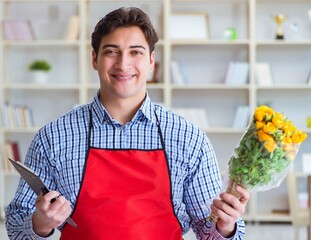 Flower shop assistant offering a bunch of flowers