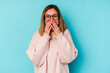 © Asier - Young student caucasian woman isolated on blue background laughing about something, covering mouth with hands.