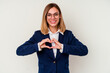 © Asier - Young business caucasian woman isolated on white background smiling and showing a heart shape with hands.
