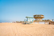 Sandy beach at Venice Beach in Los Angeles, blue lifeguard towers on a sunny day