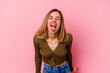 © Asier - Young caucasian woman isolated on pink background funny and friendly sticking out tongue.