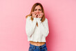 © Asier - Young caucasian woman isolated on pink background biting fingernails, nervous and very anxious.