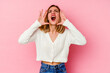 © Asier - Young caucasian woman isolated on pink background shouting excited to front.