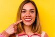 © Asier - Young caucasian woman wearing invisible orthodontics isolated on yellow background