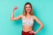 © Asier - Young sport skinny caucasian holding a dumbbell woman isolated on blue background