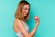 © Asier - Young sport skinny caucasian holding a dumbbell woman isolated on blue background